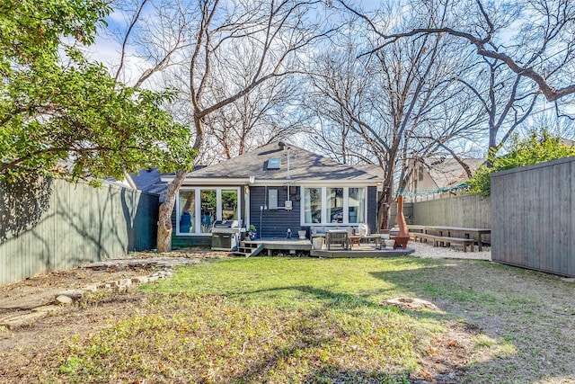 back of house featuring a yard and a deck