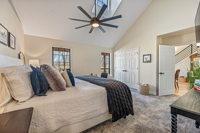 carpeted bedroom featuring ceiling fan and high vaulted ceiling