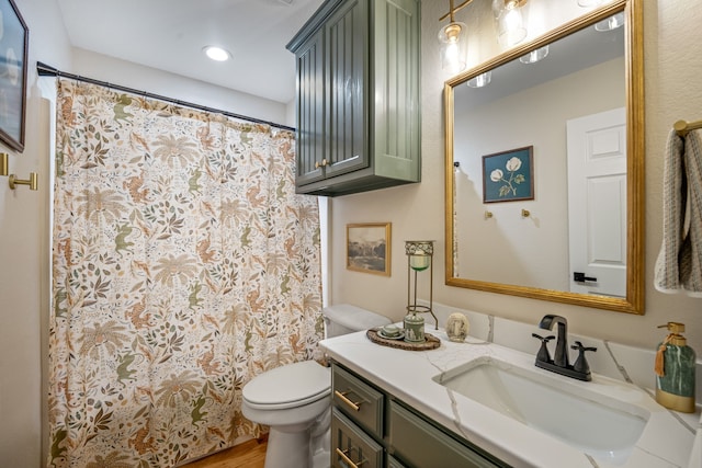 bathroom featuring vanity and toilet