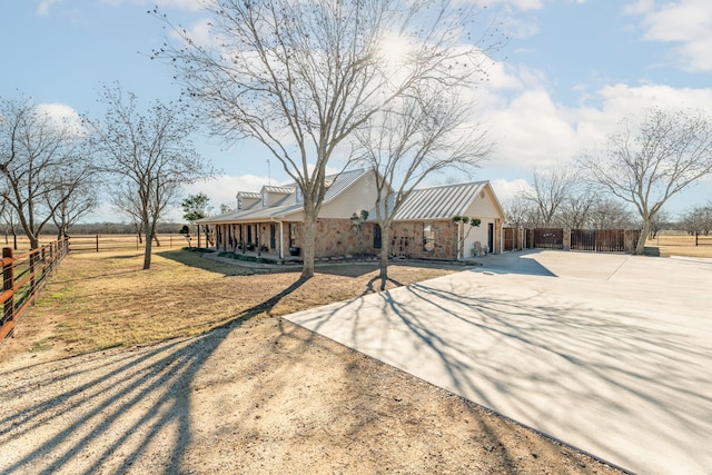 view of front of property featuring a rural view and covered porch