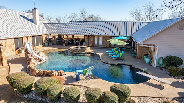 view of pool with a patio area, an in ground hot tub, french doors, and a diving board