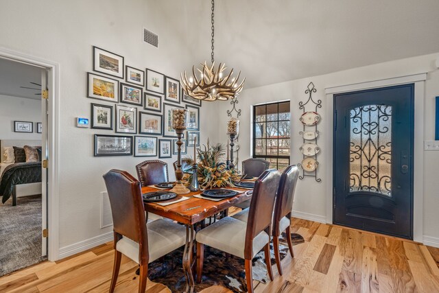 dining room featuring light hardwood / wood-style floors and a chandelier