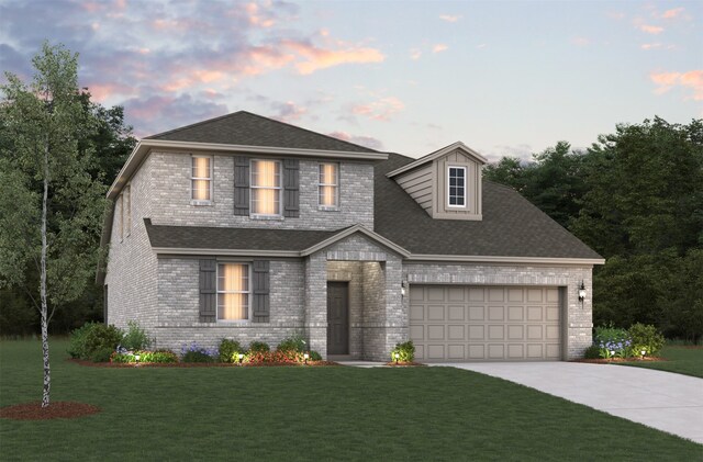 view of front facade with a yard and a garage