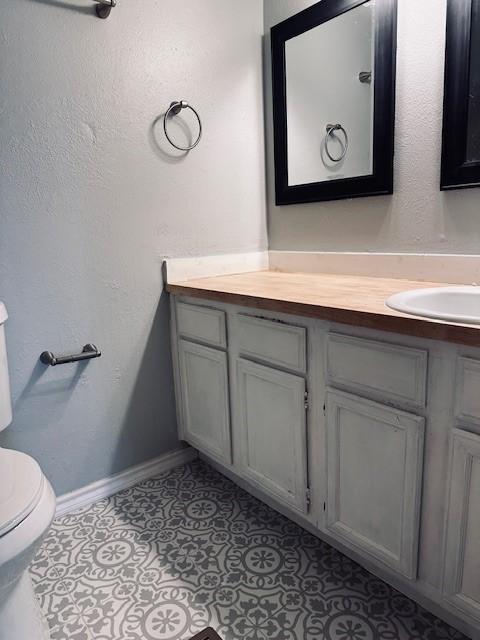 bathroom with tile patterned floors, vanity, and toilet