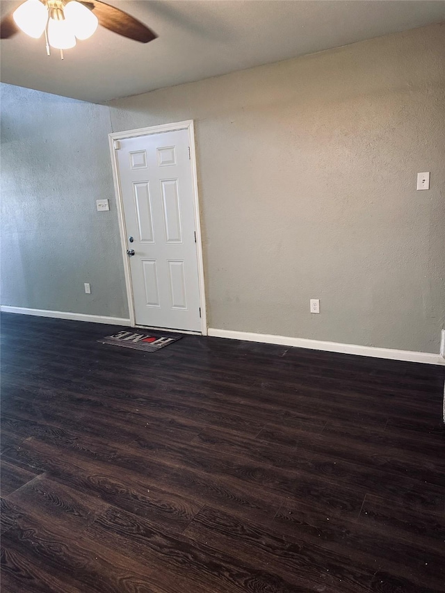 spare room featuring ceiling fan and dark hardwood / wood-style flooring