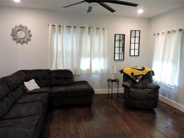 living room with dark hardwood / wood-style floors, ceiling fan, and a wealth of natural light