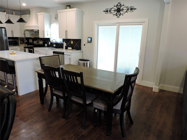 dining room featuring dark hardwood / wood-style floors, a notable chandelier, and sink