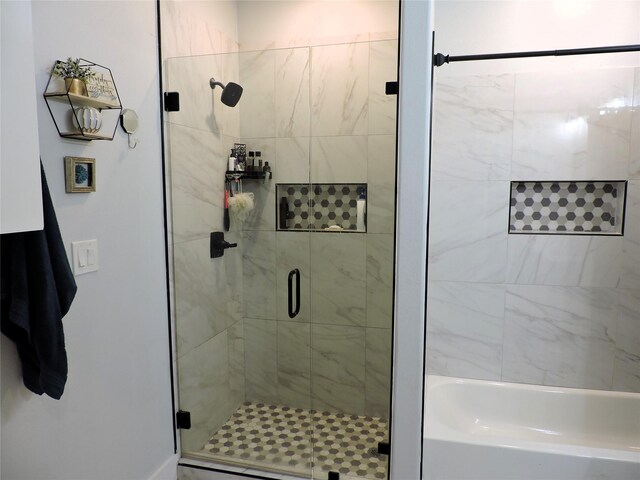 bathroom featuring a shower with door