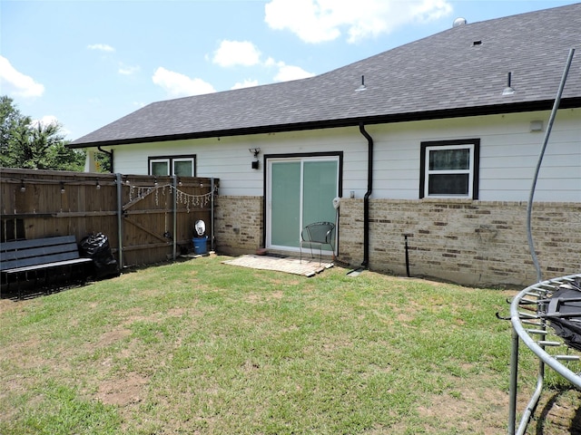 back of house with a lawn