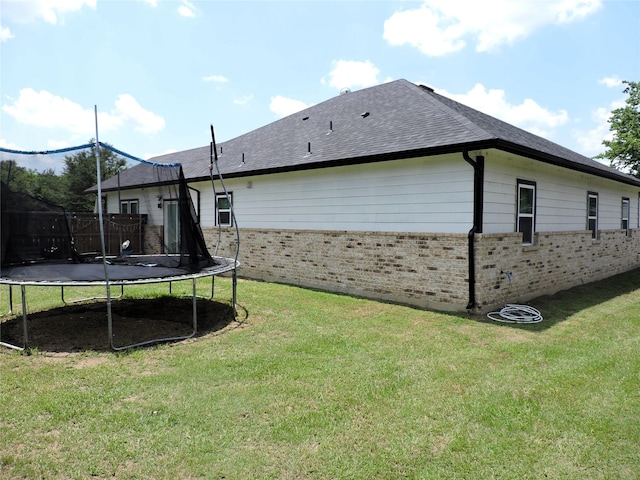 exterior space with a lawn and a trampoline