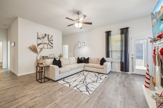 living room with hardwood / wood-style floors and ceiling fan