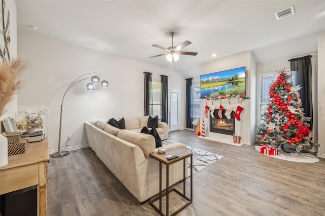 living room with hardwood / wood-style flooring and ceiling fan