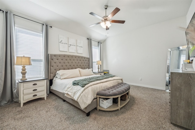 bedroom with ceiling fan, carpet floors, and vaulted ceiling