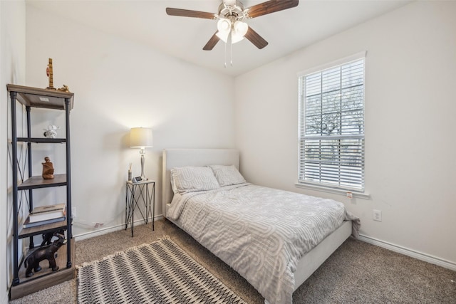 bedroom featuring ceiling fan and dark carpet