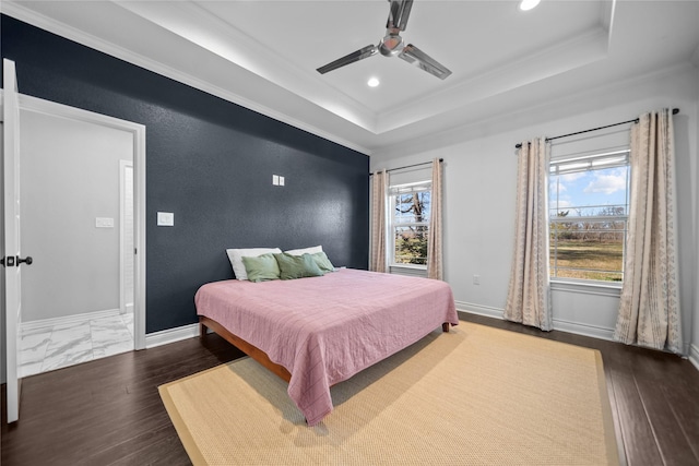 bedroom with a raised ceiling, ceiling fan, and dark wood-type flooring