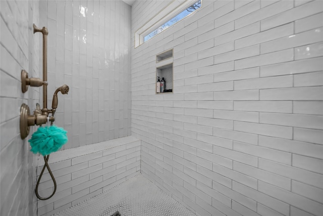 bathroom with tiled shower