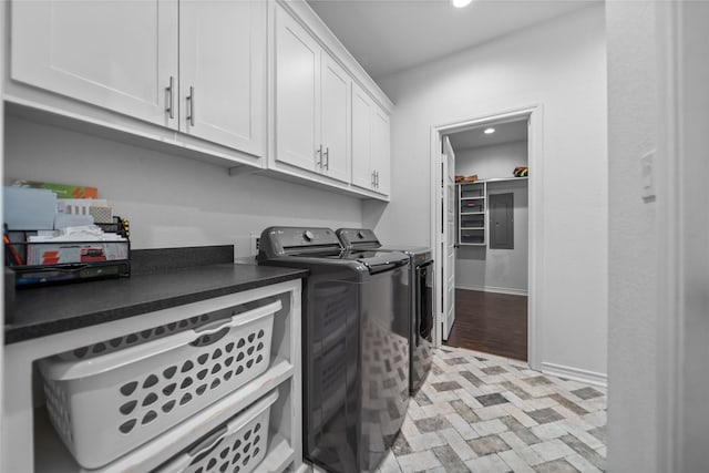 laundry room featuring washing machine and clothes dryer and cabinets