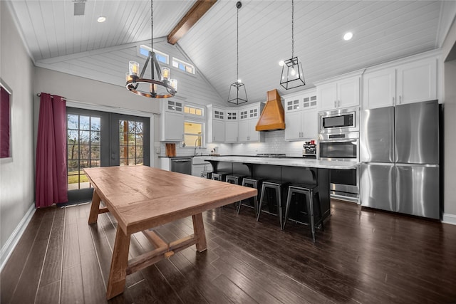 kitchen featuring pendant lighting, a center island, white cabinetry, and stainless steel appliances