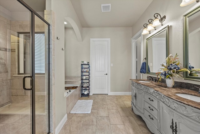 bathroom featuring tile patterned flooring, vanity, and independent shower and bath