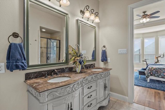 bathroom with tile patterned floors, ceiling fan, vanity, and walk in shower