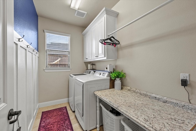 washroom featuring cabinets and washing machine and dryer