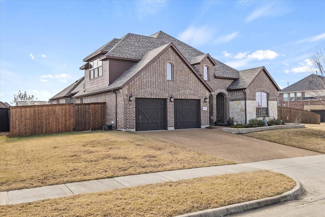 view of front of property with a garage and a front yard