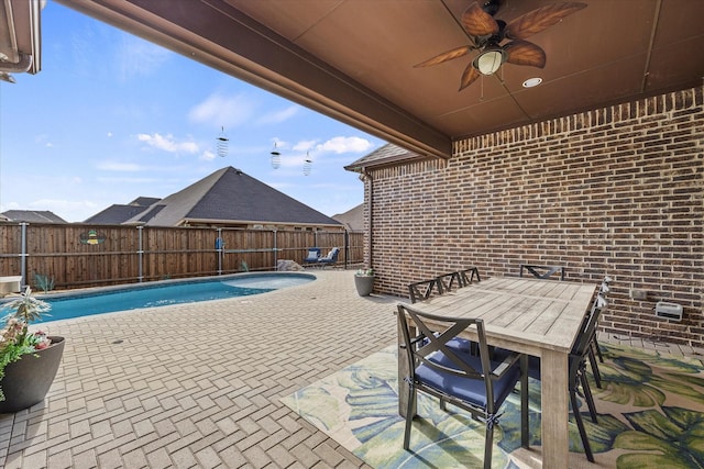 view of patio / terrace featuring a fenced in pool and ceiling fan