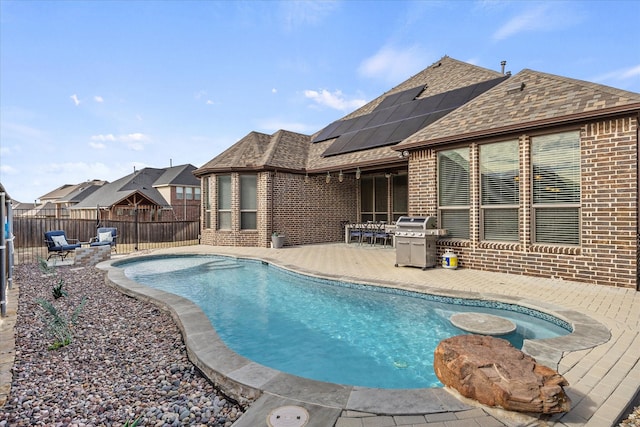 view of pool with area for grilling and a patio area