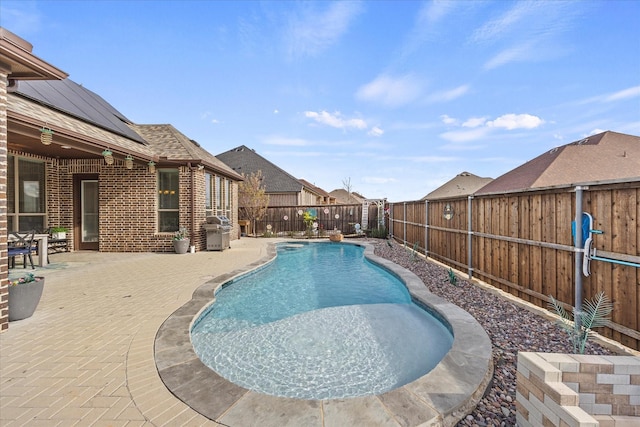 view of pool with a patio area and a grill