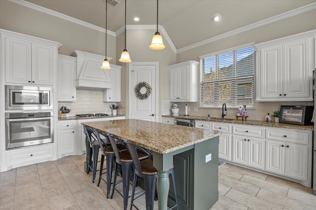 kitchen featuring appliances with stainless steel finishes, premium range hood, white cabinets, a kitchen island, and lofted ceiling