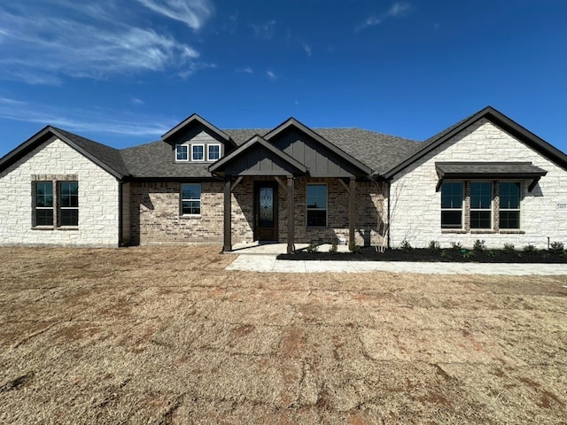 view of front of house with a shingled roof and board and batten siding