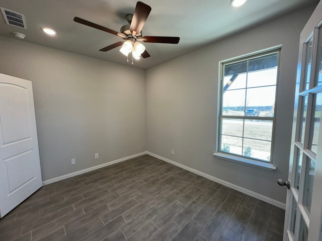 unfurnished room with baseboards, visible vents, a ceiling fan, dark wood-style flooring, and recessed lighting