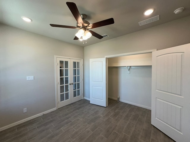 unfurnished bedroom with french doors, dark wood finished floors, visible vents, and baseboards