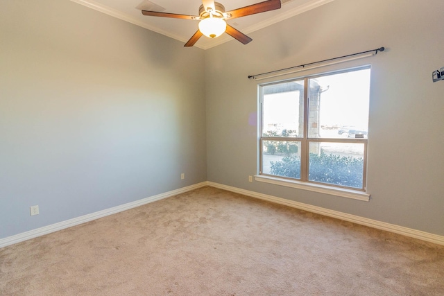 empty room featuring ornamental molding, light carpet, ceiling fan, and baseboards