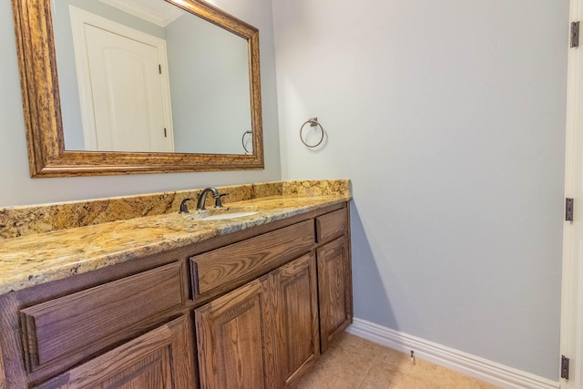 bathroom with vanity, baseboards, and tile patterned floors