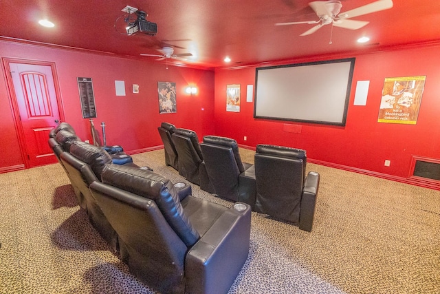 carpeted home theater room with ornamental molding, recessed lighting, a ceiling fan, and baseboards