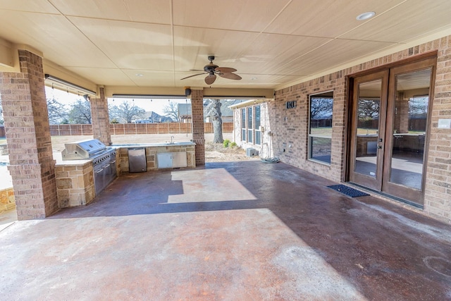 view of patio / terrace with an outdoor kitchen, grilling area, fence, french doors, and a sink