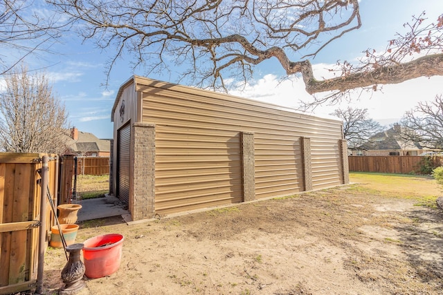 view of outbuilding featuring a fenced backyard and an outbuilding