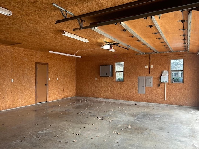 garage featuring electric panel and a garage door opener