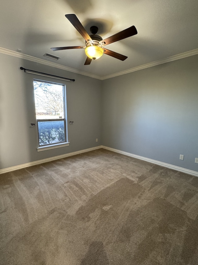 carpeted spare room featuring ornamental molding and ceiling fan