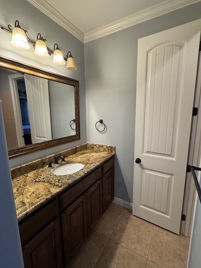 bathroom featuring tile patterned flooring, vanity, and crown molding