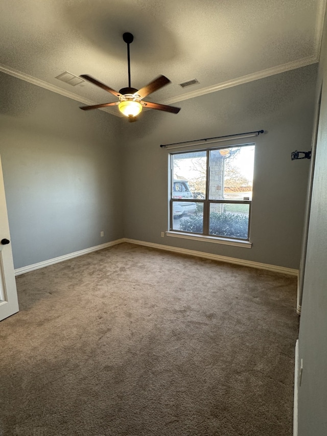 carpeted empty room featuring crown molding, a textured ceiling, and ceiling fan