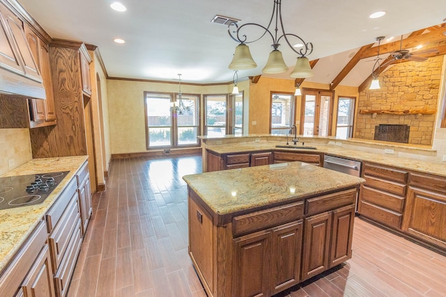 kitchen with black electric cooktop, a fireplace, a sink, visible vents, and wood tiled floor