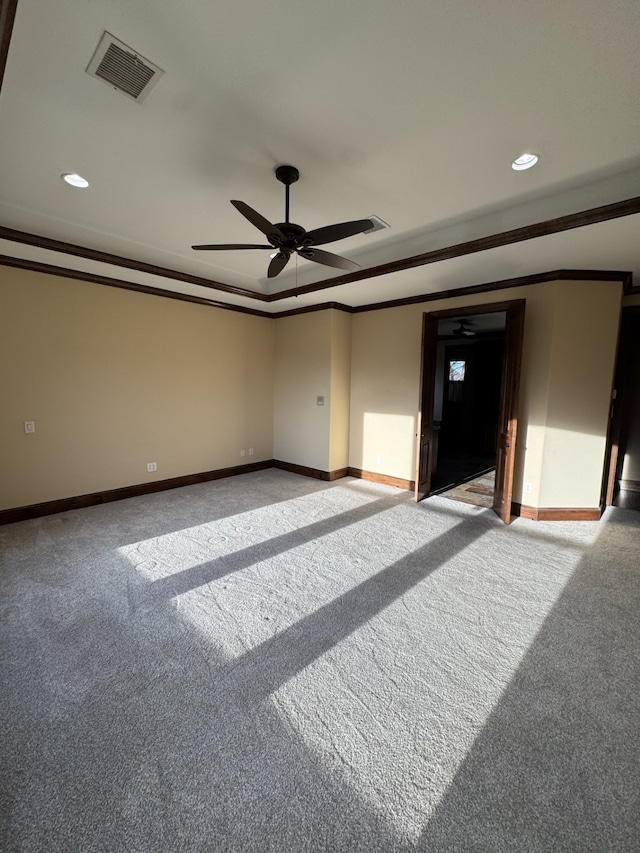 carpeted empty room featuring crown molding and ceiling fan