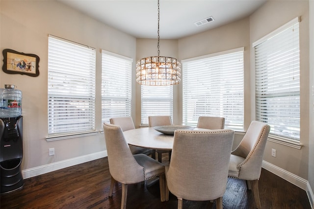 dining room featuring dark hardwood / wood-style flooring and a notable chandelier