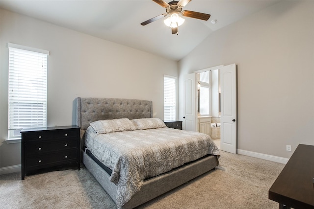 carpeted bedroom featuring multiple windows, ceiling fan, ensuite bathroom, and lofted ceiling