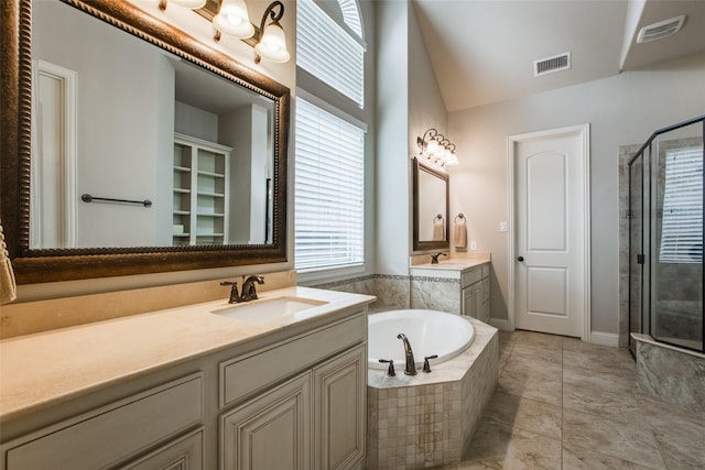 bathroom featuring plus walk in shower, tile patterned flooring, and vanity