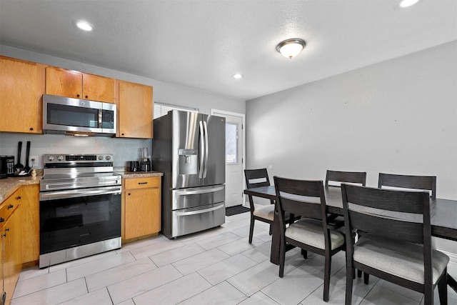 kitchen featuring appliances with stainless steel finishes and a textured ceiling