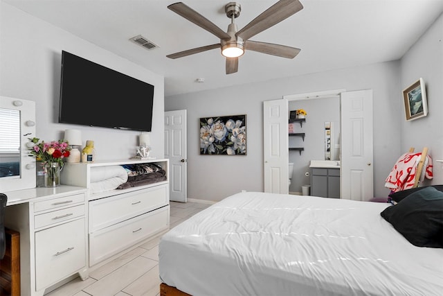 bedroom featuring ceiling fan and ensuite bathroom