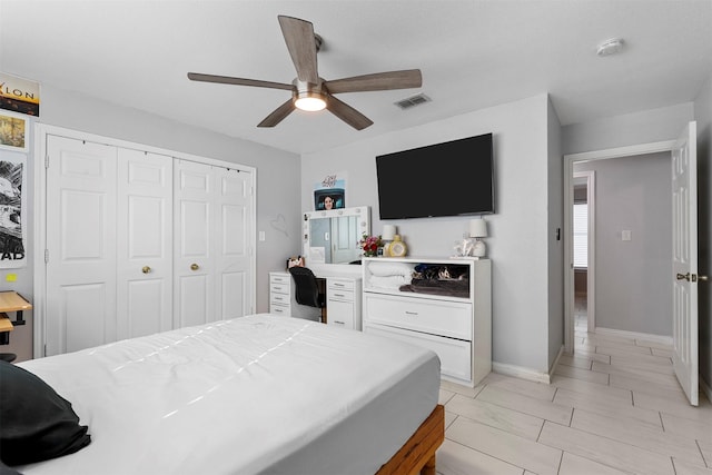 bedroom with ceiling fan and a closet